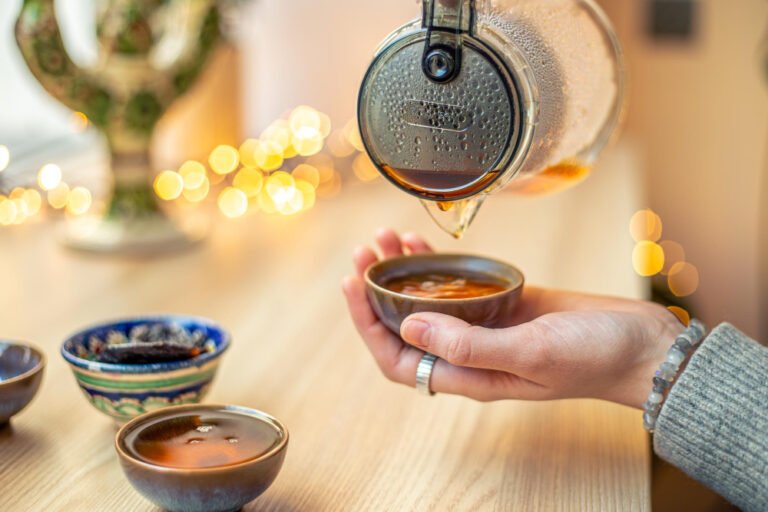 woman about to drink tea from cup.